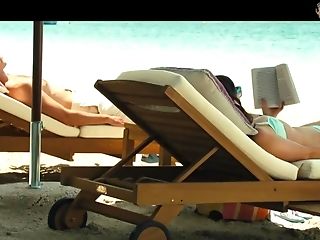 Emilia Clarke In Swim Suit Is Sunbathing By The Poolside